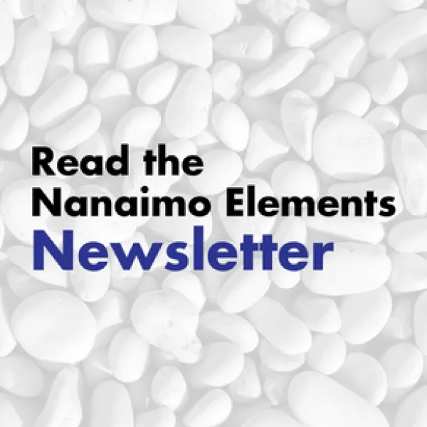 The image features a background of numerous white, rounded pebbles with the text "Read the Nanaimo Elements newsletter" overlayed in a bold blue and black font.